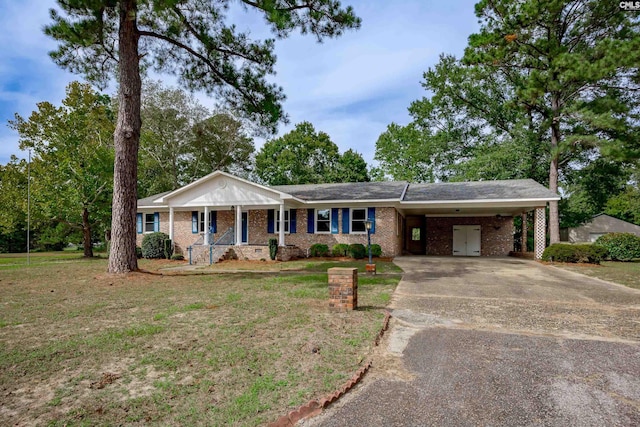 ranch-style home featuring a carport and a front yard