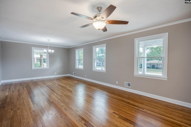 empty room with ceiling fan with notable chandelier, hardwood / wood-style flooring, crown molding, and a textured ceiling