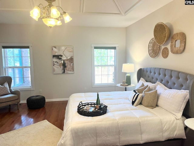 bedroom featuring a notable chandelier and dark wood-type flooring