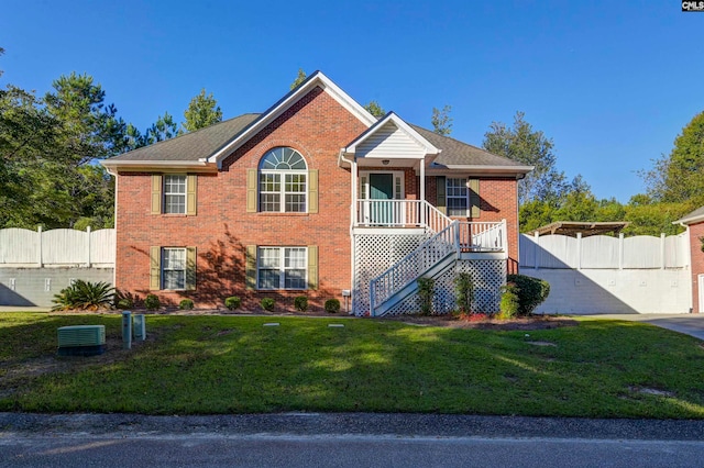 view of front of house featuring cooling unit and a front lawn