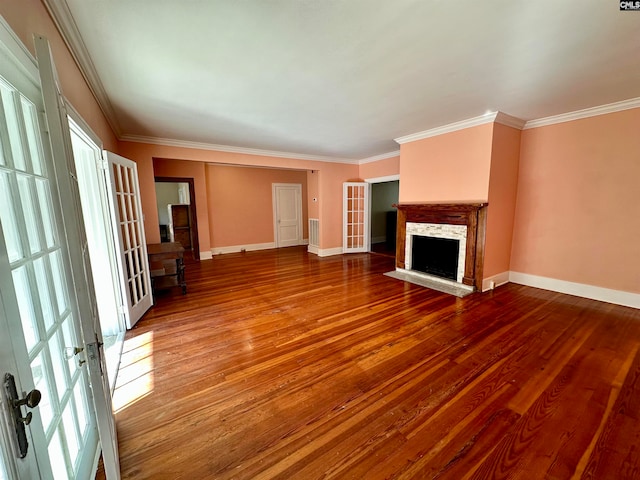 unfurnished living room featuring french doors, ornamental molding, hardwood / wood-style floors, and a healthy amount of sunlight