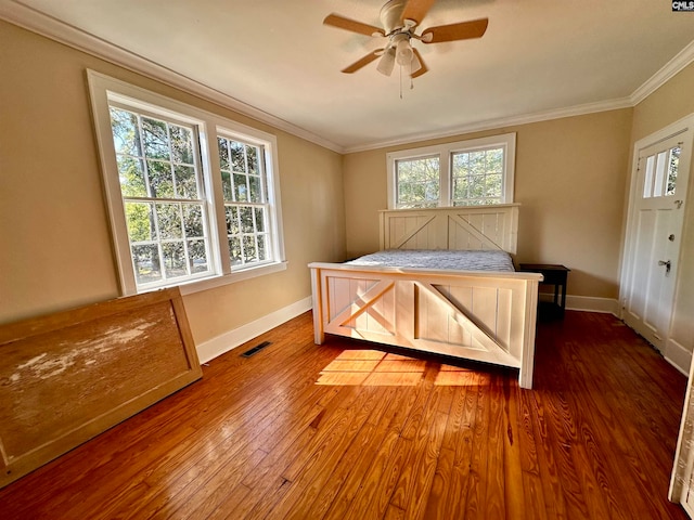 bedroom with ornamental molding, ceiling fan, and wood-type flooring