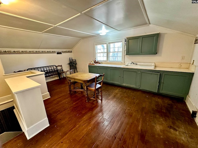 kitchen with green cabinetry, lofted ceiling, and dark hardwood / wood-style floors