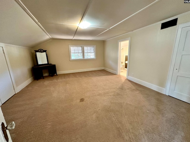 bonus room with lofted ceiling and light colored carpet