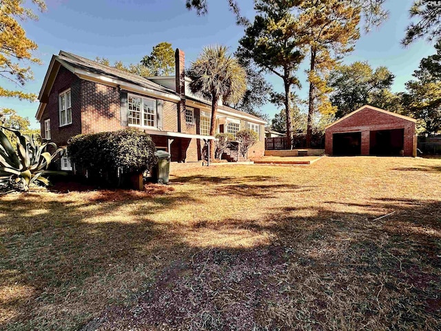 view of yard featuring an outdoor structure and a garage