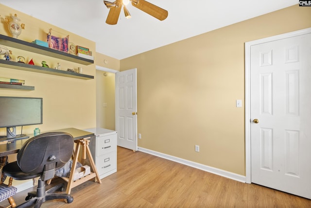 home office with light wood-type flooring and ceiling fan