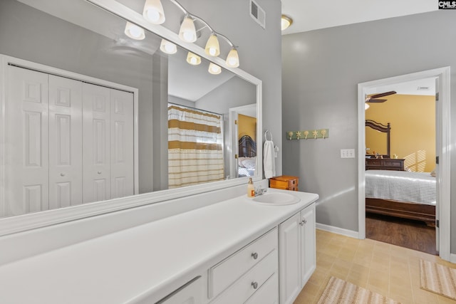 bathroom with ceiling fan, vanity, a shower with shower curtain, tile patterned floors, and vaulted ceiling