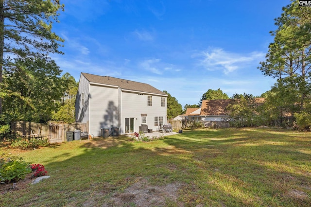 back of house with a lawn