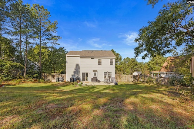 back of house with a lawn and a patio area