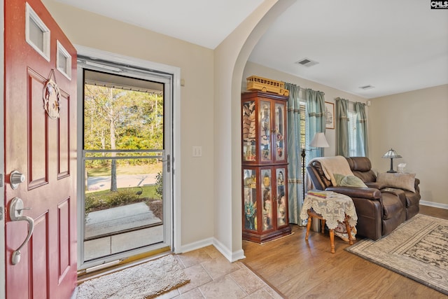 foyer entrance with light hardwood / wood-style floors