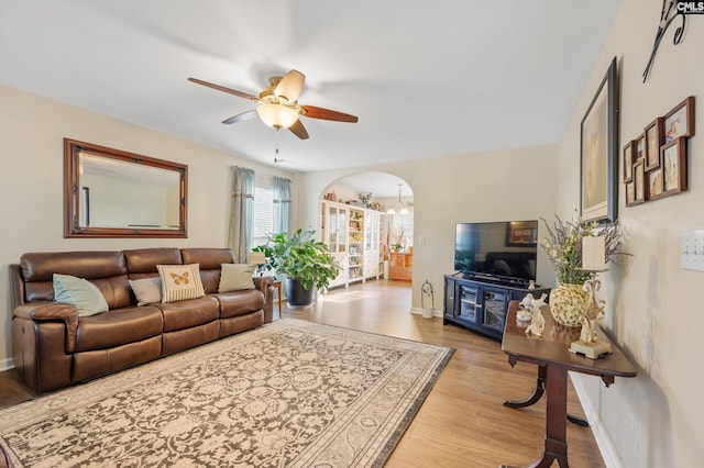 living room with light hardwood / wood-style flooring and ceiling fan