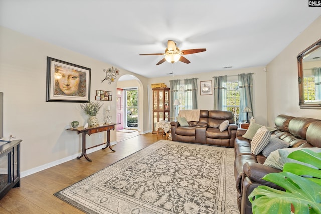 living room featuring ceiling fan, light hardwood / wood-style flooring, and a healthy amount of sunlight