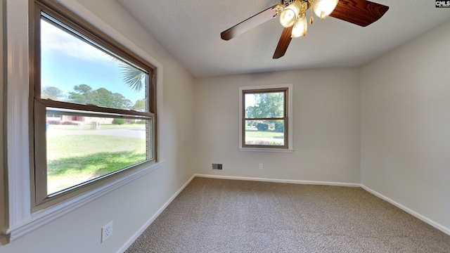 carpeted empty room featuring ceiling fan