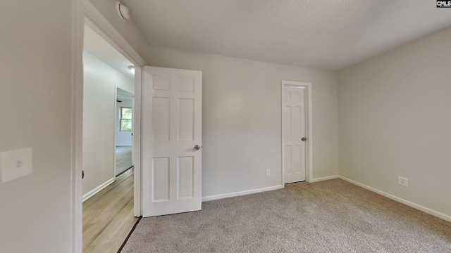 unfurnished bedroom featuring light carpet