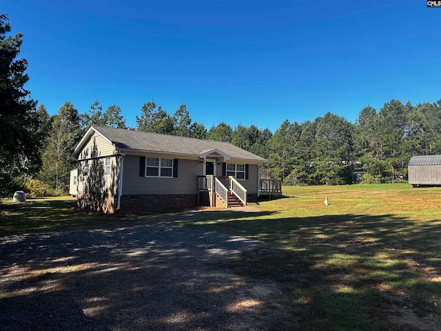 single story home with a front lawn and a wooden deck