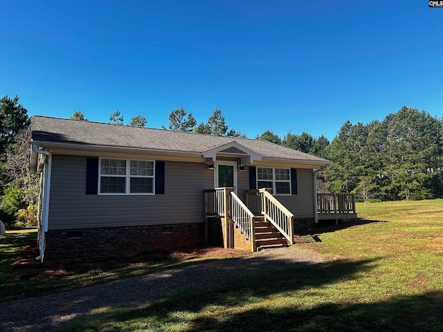 view of front of house with a front yard and a wooden deck