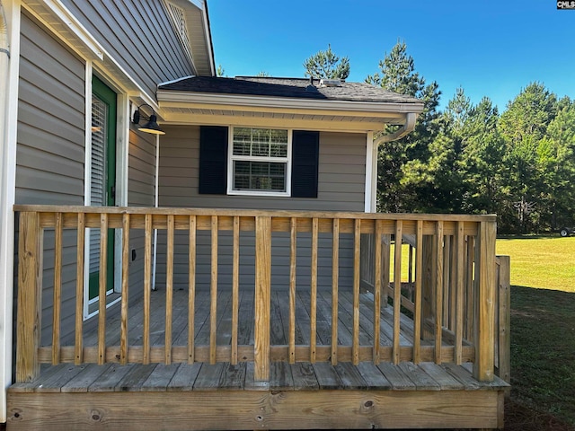 wooden terrace featuring a yard