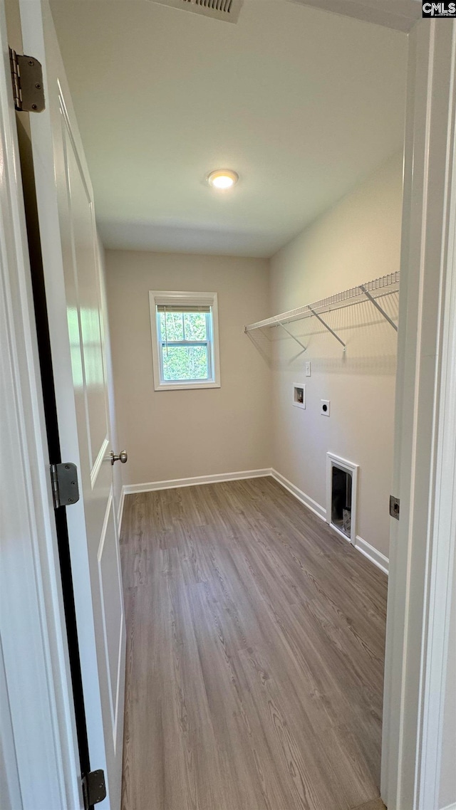 washroom featuring hookup for an electric dryer, hookup for a washing machine, and light hardwood / wood-style floors