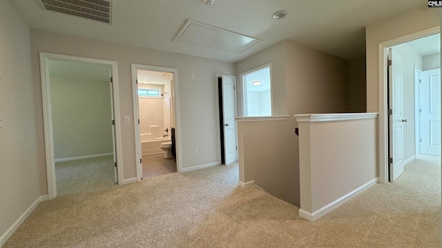 hallway featuring light carpet