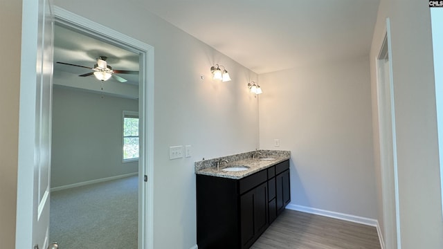 bathroom featuring ceiling fan and vanity