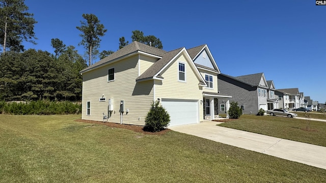 view of side of property with a garage and a yard