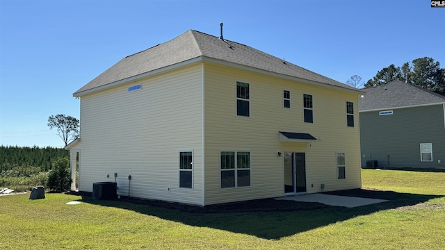 rear view of house with a patio, a lawn, and central air condition unit