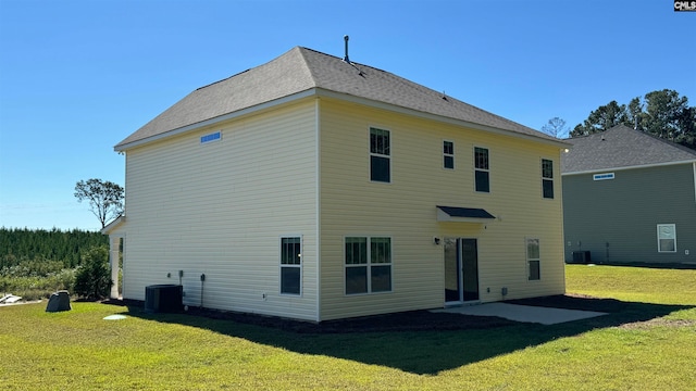 rear view of property with cooling unit, a yard, and a patio