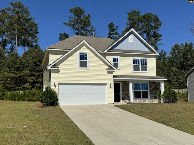 craftsman house with a front yard and a garage