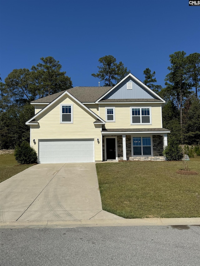 view of front of home with a garage and a front lawn