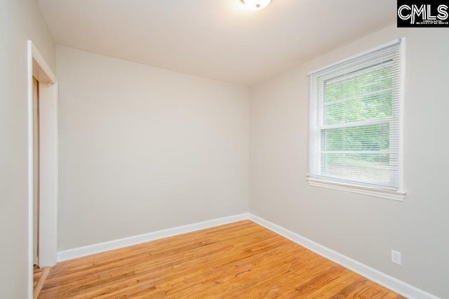 unfurnished room featuring hardwood / wood-style floors