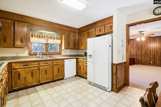 886 Polson Rd, Camden, SC 29020 - kitchen featuring a sink, light floors, white appliances, and wooden walls