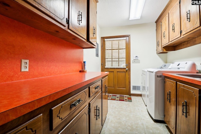 886 Polson Rd, Camden, SC 29020 - laundry room featuring visible vents, cabinet space, and washer and dryer