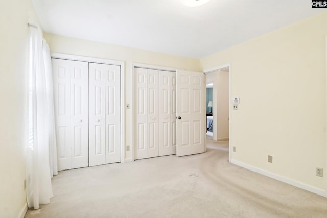 886 Polson Rd, Camden, SC 29020 - unfurnished bedroom with two closets, carpet flooring, and baseboards