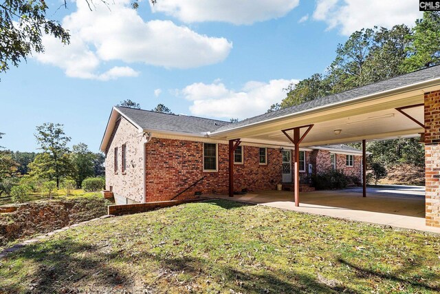 886 Polson Rd, Camden, SC 29020 - rear view of property featuring a lawn and brick siding