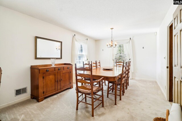 886 Polson Rd, Camden, SC 29020 - dining area featuring visible vents, baseboards, light carpet, and an inviting chandelier