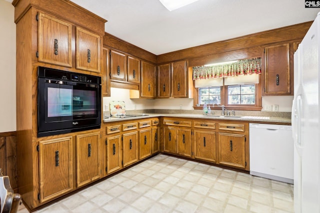 886 Polson Rd, Camden, SC 29020 - kitchen featuring brown cabinets, a sink, light countertops, light floors, and white appliances