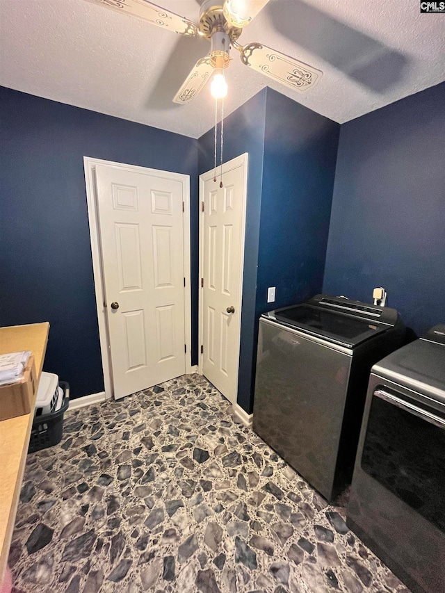 laundry room with washer and dryer, a textured ceiling, and ceiling fan