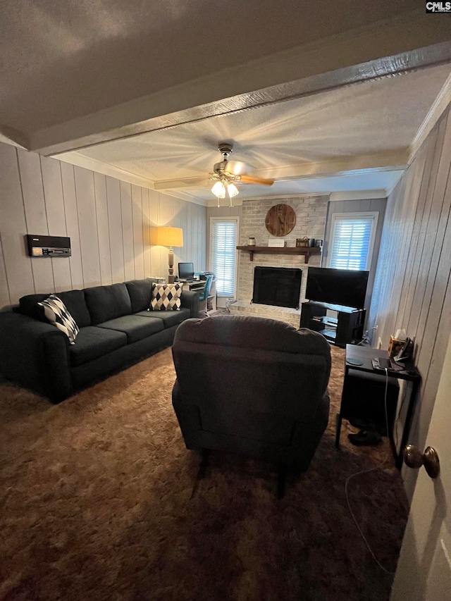 living room with a brick fireplace, ceiling fan, carpet flooring, and a healthy amount of sunlight