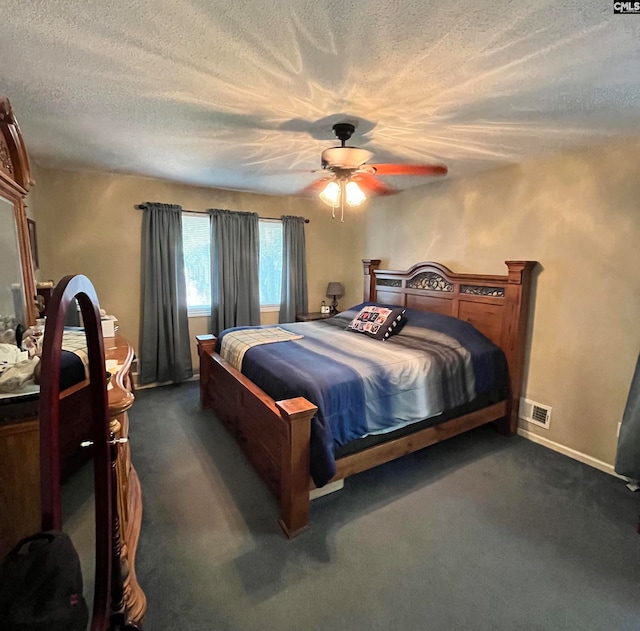 carpeted bedroom with ceiling fan and a textured ceiling