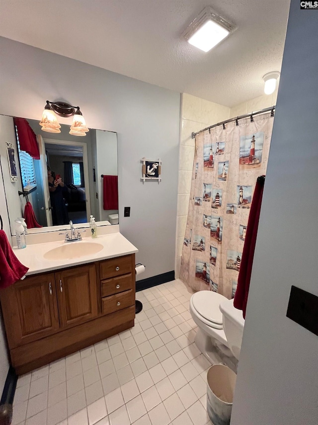 bathroom with toilet, curtained shower, tile patterned floors, vanity, and a textured ceiling