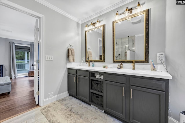 bathroom featuring ornamental molding, an enclosed shower, vanity, and hardwood / wood-style floors