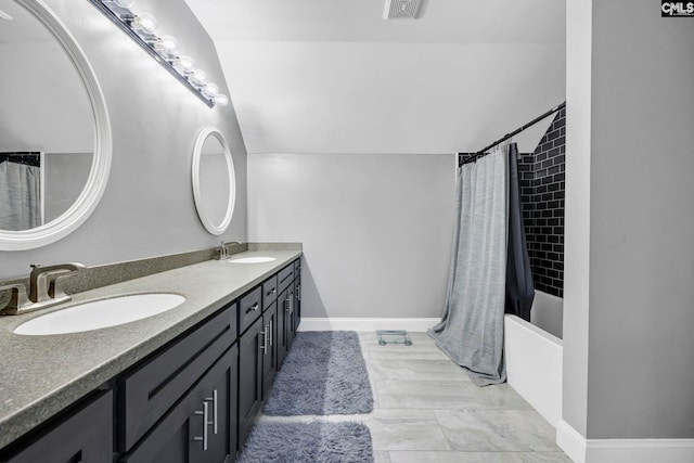 bathroom with vanity, lofted ceiling, and shower / tub combo