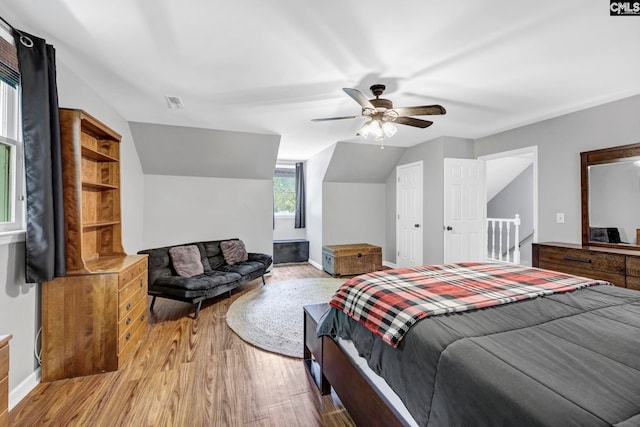 bedroom featuring lofted ceiling, light hardwood / wood-style flooring, and ceiling fan