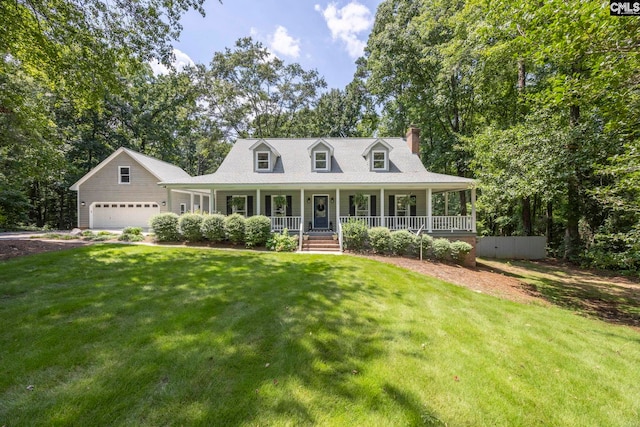 new england style home with a porch, a front yard, and a garage