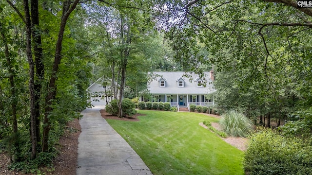 cape cod-style house with a garage and a front lawn