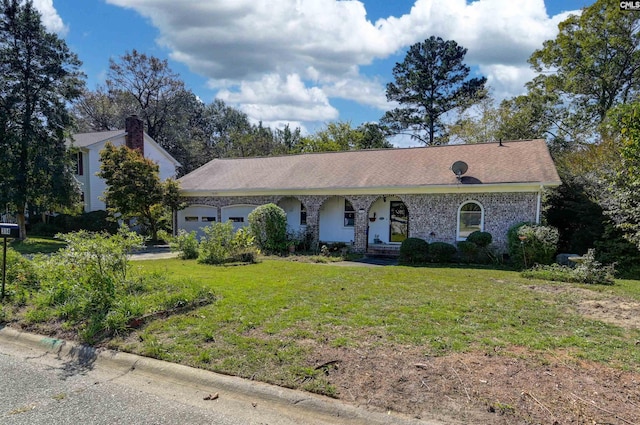 ranch-style house featuring a front yard and a garage