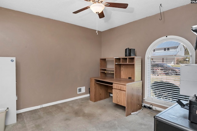 carpeted office with ceiling fan and a textured ceiling