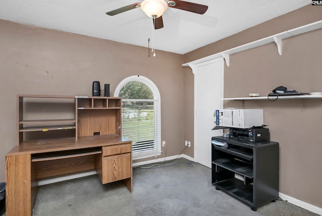 office space with carpet, a textured ceiling, and ceiling fan