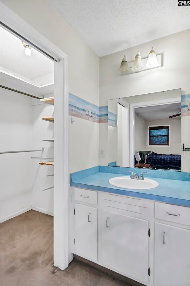 bathroom with vanity and a textured ceiling