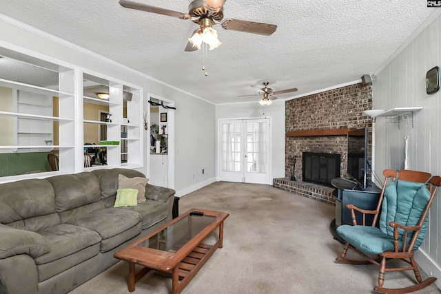 carpeted living room featuring wood walls, ceiling fan, a fireplace, ornamental molding, and a textured ceiling